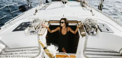 Guest with champagne in the companionway of the Lady Sunshine